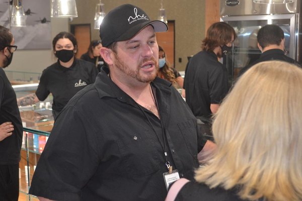 Natural Healing Center (NHC) founder Helios Dayspring talks to customers after opening Lemoore's second cannabis dispensary in Lemoore Saturday, July 4.